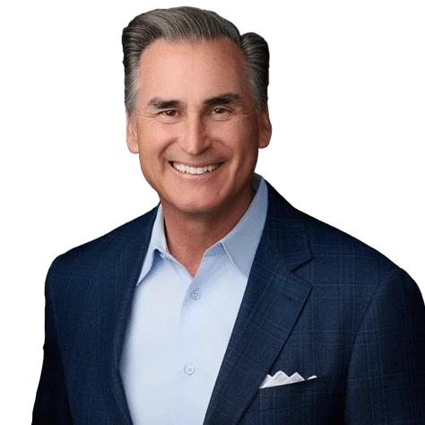 Professional headshot of Tim Ristoff, Chairman of the Play It Forward Initiative, smiling in a blue suit jacket and light blue shirt.
