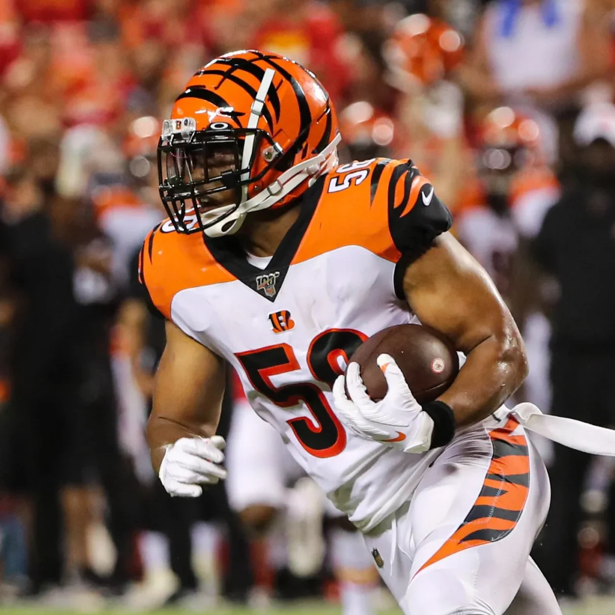 NFL linebacker Hardy Nickerson Jr. running during a game in his white, black, and orange Cincinnati Bengals uniform.